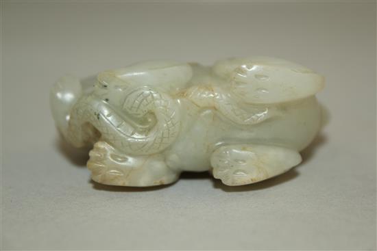 A Chinese pale celadon jade group of a lion-dog and a snake, 6.3cm